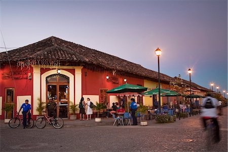 Man rideing bike past restaurant on Calle La Calzada, Granada, Nicaragua, Central America Stock Photo - Rights-Managed, Code: 841-03517067