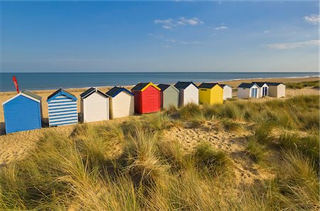 suffolk - Brightly painted beach huts, rear view, in the afternoon sunshine below Gun Hill, Southwold, Suffolk, England, United Kingdom, Europe Stock Photo - Rights-Managed, Code: 841-03517216