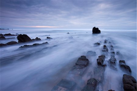 enigma - Waves rush over the rocky ledges at Sandymouth Bay in North Cornwall, England, United Kingdom, Europe Stock Photo - Rights-Managed, Code: 841-03518690