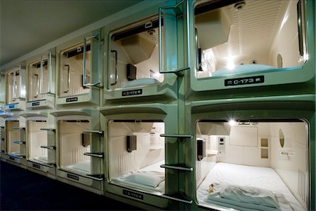 Rows and stacks of sleeping compartments along one corridor at a capsule hotel in Osaka, Japan, Asia Stock Photo - Rights-Managed, Code: 841-03520256