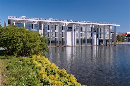 Radhus (City Hall), a contemporary concrete-and-glass building built in 1987 on the shores of Lake Tjornin, Reykjavik, Iceland, Polar Regions Stock Photo - Rights-Managed, Code: 841-03674777