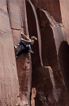A rock climber tackles an overhanging crack in a sandstone wall on the cliffs of Indian Creek, a famous rock climbing area in Canyonlands National Park, near Moab, Utah, United States of America, North America Stock Photo - Rights-Managed, Code: 841-03675350