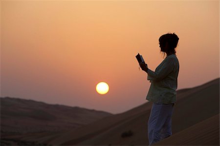 Woman reading the Bible in the desert, Abu Dhabi, United Arab Emirates, Middle East Stock Photo - Rights-Managed, Code: 841-03675921