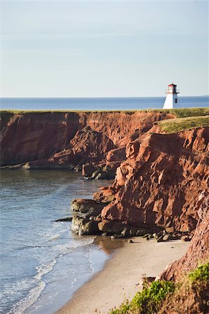 Lighthouse on a cliff overlooking a sandy beach on Havre-Aubert Island in the Iles de la Madeleine (Magdalen Islands), Quebec, Canada, North America Stock Photo - Rights-Managed, Code: 841-03677079
