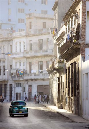 simsearch:841-03035281,k - Old American car driving along quiet street in Havana Centro, Havana, Cuba, West Indies, Caribbean, Central America Stock Photo - Rights-Managed, Code: 841-03672426