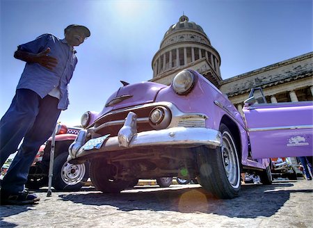 simsearch:841-03035281,k - Low angle shot of The Capitolio with classic American car and old man in foreground, Havana, Cuba, West Indies, Caribbean, Central America Stock Photo - Rights-Managed, Code: 841-03672428