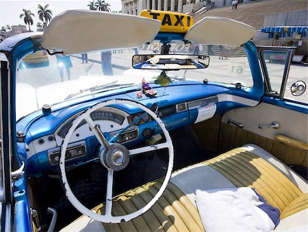 simsearch:841-03035281,k - Interior of old American car being used as a taxi showing blue dashboard, original steering wheel and leather seats, parked outside The Capitolio, Havana, Cuba, West Indies, Central America Stock Photo - Rights-Managed, Code: 841-03672435