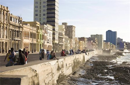 seawall - View along The Malecon showing people sitting on the seawall enjoying the evening sunshine, Havana, Cuba, West Indies, Central America Stock Photo - Rights-Managed, Code: 841-03672440
