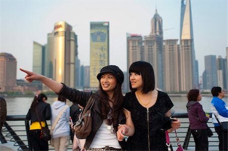 Tourists smiling and pointing, The Bund, Huangpu District, with Pudong District on the background, Shanghai, China, Asia Stock Photo - Rights-Managed, Code: 841-03871467