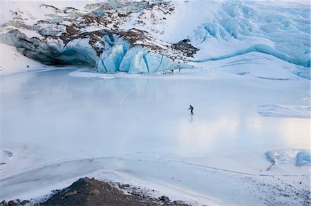 Woman ice skating in front of Saddlebag Glacier, Chugach Mountains near Cordova, Southcentral Alaska, Winter Stock Photo - Rights-Managed, Code: 854-05974496