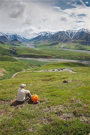 simsearch:693-06667811,k - A Senior Male Hiker Sitting On The Tundra On The Mountain Side Looking Down At The Eielson Visitor's Center In Denali National Park; Alaska United States Of America Stock Photo - Rights-Managed, Code: 854-08028072