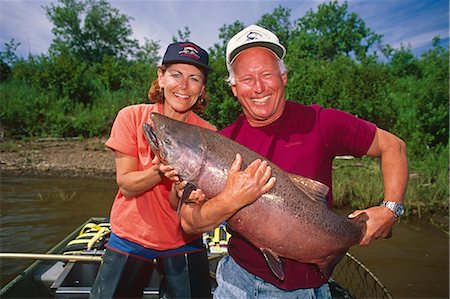 river fish - Fisherman & woman holding large king salmon in boat Nushagak River Southwest AK Summer Stock Photo - Rights-Managed, Code: 854-02954993