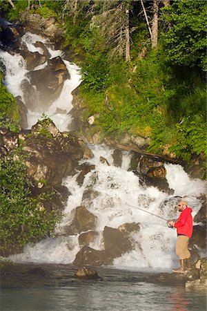 Fisherman spin fishing for salmon at the base of Fisher Falls at Big River Lakes in Redoubt Bay State Critical Habitat Area, Southcentral Alaska Stock Photo - Rights-Managed, Code: 854-02955004