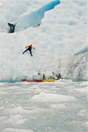 Man ice climbs onto Bear Glacier in Kenai Fjords National Park after exiting his sea kayak Stock Photo - Rights-Managed, Code: 854-02955033