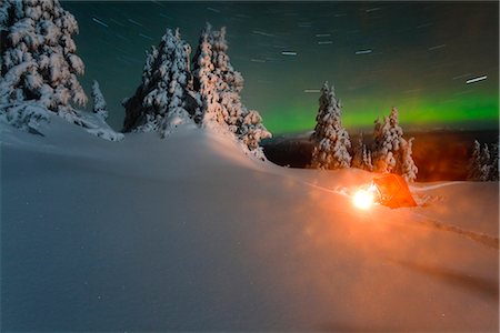 Winter camper prepares breakfast during pre-dawn on a snowcovered subalpine ridge with Northern Lights overhead, Wrangell Island, Alaska Stock Photo - Rights-Managed, Code: 854-02955073