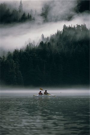 Couple sea kayaking in Red Bluff Bay w/mist rolling off Baranof Isl Chatham Strait Southeast Alaska Stock Photo - Rights-Managed, Code: 854-02955145
