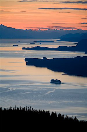 ship in the sunset - Sunset with Cruise ship heading north in Stephens Passage west of Juneau Southeast Alaska Stock Photo - Rights-Managed, Code: 854-02955634