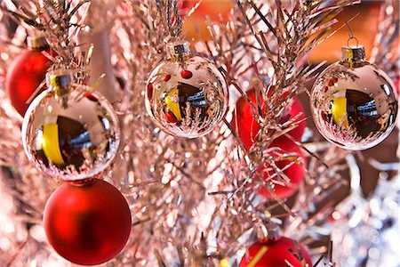 december - Silver and red Christmas tree bulb ornaments hanging from bright tinsel tree reflecting other ornaments winter Alaska Stock Photo - Rights-Managed, Code: 854-02955832