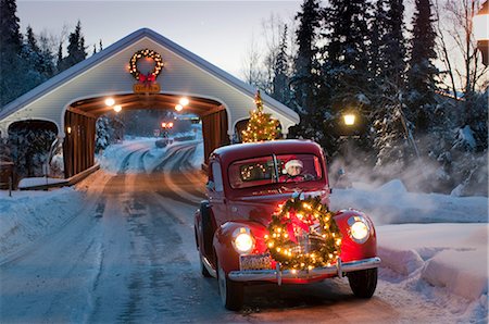 retro christmas trees - Man driving a vintage 1941 Ford pickup through a covered bridge with a Christmas wreath on the grill and a tree in the back during Winter in Southcentral, Alaska Stock Photo - Rights-Managed, Code: 854-02955865