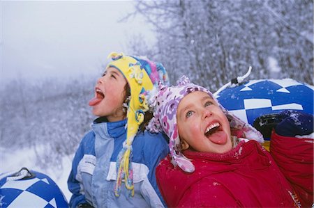 Young girls catching snowflakes on their tongues while out sledding Girdwood Alaska Southcentral Winter Stock Photo - Rights-Managed, Code: 854-02955921