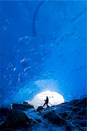 Photographer carrys his camera and tripod into the entrance of an ice cave at Mendenhall Glacier near Juneau. Summer in Southeast Alaska. Stock Photo - Rights-Managed, Code: 854-02956119