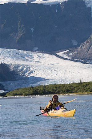 Man sea kayaking in Aialik Bay with Pederson Glacier in the background in Kenai Fjords National Park Stock Photo - Rights-Managed, Code: 854-03538082