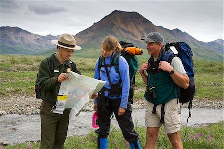 simsearch:854-03538162,k - Native Indian National Park Service Ranger talks and shows map to couple along the Toklat River Denali NP Alaska Stock Photo - Rights-Managed, Code: 854-03538120