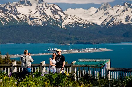 Tourists take pictures of the view of the Homer Spit, Kachemak Bay and the Kenai Mountains from the Baycrest Overlook on the Sterling Highway, Alaska Stock Photo - Rights-Managed, Code: 854-03538597