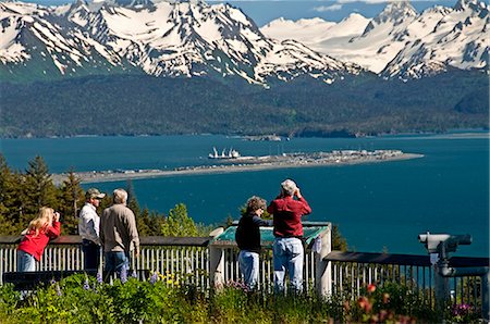 Tourists take pictures of the view of the Homer Spit, Kachemak Bay and the Kenai Mountains from the Baycrest Overlook on the Sterling Highway, Alaska Stock Photo - Rights-Managed, Code: 854-03538598