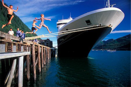 person cruise ship - Children jumping off of a commercial dock into the water with a cruise ship moored close by in Juneau Alaska during Summer Stock Photo - Rights-Managed, Code: 854-03538676