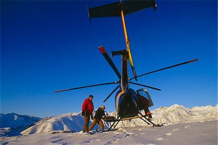 ski touring - Heli-skiing crew unloads gear from helicopter atop mountain ridge Chugach Mtns Southcentral Alaska Winter Stock Photo - Rights-Managed, Code: 854-03538714