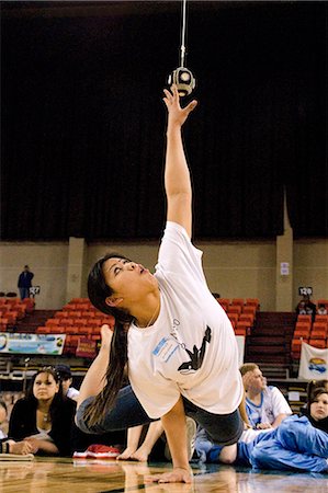 simsearch:854-03538943,k - Girl doing One Hand Reach 2006 Senior Native Youth Olympic Games Alaska Anchorage Sullivan Arena Stock Photo - Rights-Managed, Code: 854-03538936