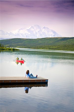 Mature couple canoes on Wonder Lake as middle age woman watches from dock with Mt. Mckinley in the background, Denali National Park, Alaska Stock Photo - Rights-Managed, Code: 854-03539381