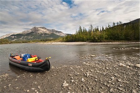 An inflatable canoe rests on the shore of the Alatna River during a backcountry trip in Gates of the Arctic National Park & Preserve, Arctic Alaska, Summer Stock Photo - Rights-Managed, Code: 854-03645867