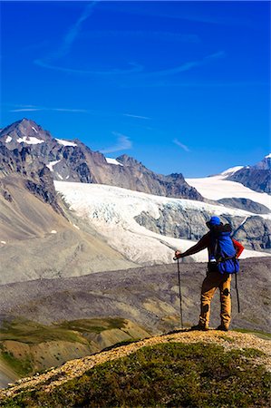 Male backpacker stops to view Gulkana Glacier while hiking in the Alaska Range, Southcentral Alaska, Summer/n Stock Photo - Rights-Managed, Code: 854-03645934