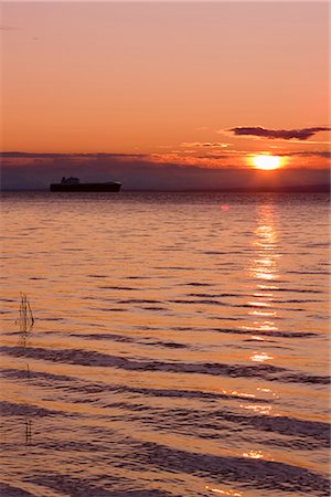 simsearch:854-03362156,k - View of cargo ship sailing up Knik Arm towards the Port of Anchorage at sunset, Southcentral, Alaska, Summer Stock Photo - Rights-Managed, Code: 854-03646329