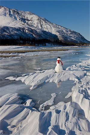 simsearch:854-03846022,k - Snowman with a red scarf and black top hat sitting on the frozen Nenana River with the Alaska Range foothills in the background, Southcentral Alaska, Winter Stock Photo - Rights-Managed, Code: 854-03646518