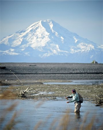 river fish - Woman fly fishing for wild Steelhead on Deep Creek with Mt. Redoubt in the background, Kenai Peninsula, Southcentral Alaska, Autumn Stock Photo - Rights-Managed, Code: 854-03739510