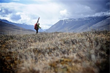 Backcountry skier hikes with pack and skis above the Hulahula River, Brooks Range, ANWR, Arctic Alaska, Summer Stock Photo - Rights-Managed, Code: 854-03740043