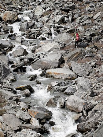 Backpacker next to a creek in the Katak Creek valley hiking to Mt. Chamberlin ski descent, Brooks Range, ANWR, Arctic Alaska, Summer Stock Photo - Rights-Managed, Code: 854-03740071
