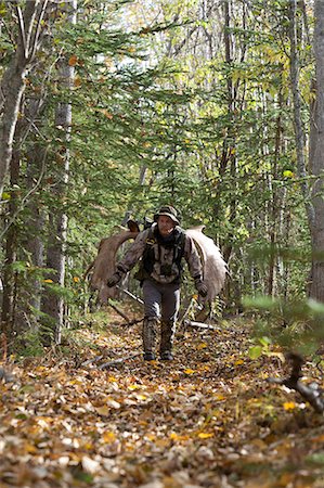 sports and hiking - Male bow hunter carries a 54" moose antler rack on his backpack as he hikes out of hunt area, Eklutna Lake area, Chugach State Park, Southcentral Alaska, Autumn Stock Photo - Rights-Managed, Code: 854-03844991