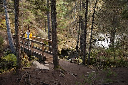 person crossing a gorge - Woman hiking on a bridge that overlooks the falls on Winner Creek Trail in near Girdwood, Chugach National Forest, Southcentral Alaska, Autumn Stock Photo - Rights-Managed, Code: 854-03845033