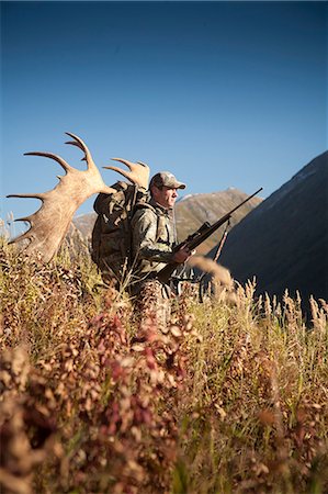simsearch:400-08348524,k - Male moose hunter stops to enjoy the view as he hikes out of hunt area with trophy moose antler on his pack, Bird Creek drainage area, Chugach Mountains, Chugach National Forest, Southcentral Alaska, Autumn Stock Photo - Rights-Managed, Code: 854-03845063