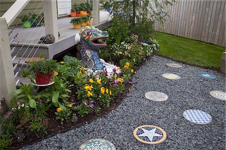 south west - Mosaic dragon and other yard decor in a backyard garden in Kodiak, Kodiak Island, Southwest Alaska, Summer Stock Photo - Rights-Managed, Code: 854-03845198