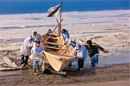 Whaling crew pushes their Umiaq off the Chuchki Sea ice at the end of the spring whaling season in Barrow, Arctic Alaska, Summer Stock Photo - Rights-Managed, Code: 854-03845486