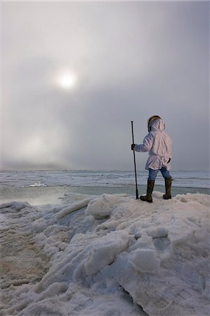 Male Inupiaq Eskimo hunter wearing his Eskimo parka (Atigi) and carrying a walking stick while looking out over the Chukchi Sea, Barrow, Arctic Alaska, Summer Stock Photo - Rights-Managed, Code: 854-03845520