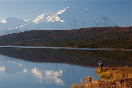 Fly fisherman casting over Wonder lake with the northside of Mt. McKinley in the background, Denali National Park and Preserve, Interior Alaska, Fall Stock Photo - Rights-Managed, Code: 854-03845705