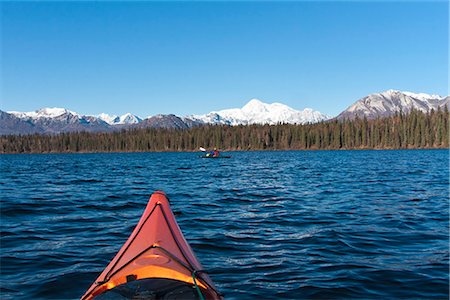 personal perspective - Woman kayaking in Byers Lake as seen from another kayaker's point of view with scenic view of Mt. McKinley on a clear sunny day, Denali State Park, Southcentral Alaska, Autumn Stock Photo - Rights-Managed, Code: 854-03845987