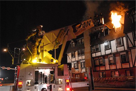 Members of the Anchorage Fire Department work during a cold winter night to extinguish a blaze at the King's Court apartment building near downtown, Southcentral Alaska, Winter Stock Photo - Rights-Managed, Code: 854-03845990