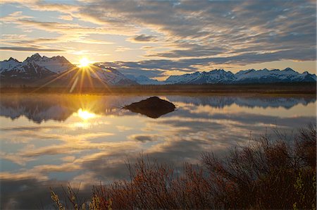 Sun rises over the Chugach Mountains with a pond and beaver lodge in the foreground, Copper River Highway, Chugach National Forest, Southcentral Alaska, Spring, HDR Stock Photo - Rights-Managed, Code: 854-03846098